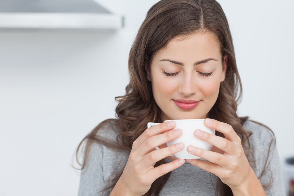Woman Savoring Coffee in the Kitchen